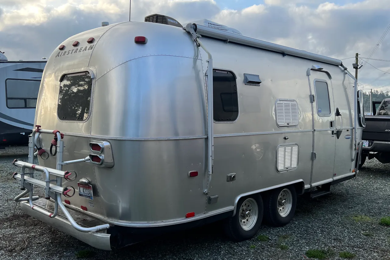 Blue Moose Airstream entry side with awning and rear bike rack